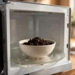 bowl of coffee grounds placed to remove burnt popcorn smell out of microwave