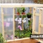 homemade wooden mini greenhouse with plastic cover and orchids - diy greenhouse ideas