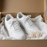 white sneakers stored in a box with tissue to keep white sneakers from yellowing